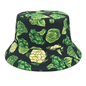 Detailed close-up of a black bucket hat featuring green broccoli and cabbage patterns