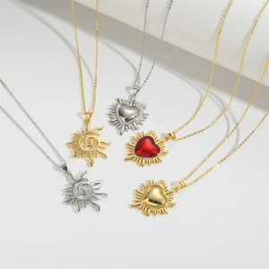 Set of five minimalist sun and heart pendant necklaces in polished gold and silver finish