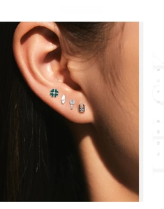Close-up of four-piece s925 silver stud earring set with green clover and key lock