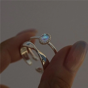Close-up of a 925 sterling silver set featuring a moonstone ring and wavy textured band