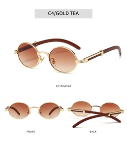Detail view of oval wood-grain sunglasses with gold metal frame and tea lenses