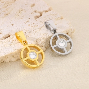 Detail of geometric circular pendants in gold and silver with sparkling center crystals