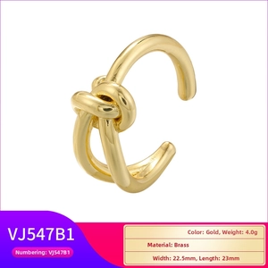 Macro detail of gold twisted knot brass cuff earring with precise dimensions and weight