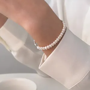 Elegant S925 sterling silver pearl bracelet with smooth white pearls on a silk background