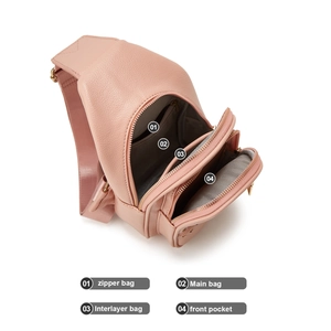 Detail view of pink pebbled leather crossbody bag showing four functional inner compartments