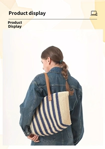 Detail of blue striped straw tote bag with brown leather handles and metal rivets
