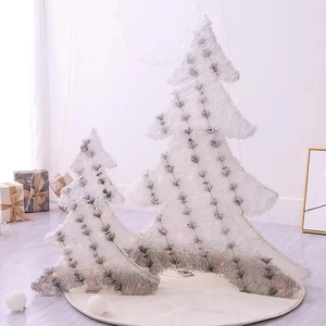 Set of two white flocked glowing Christmas trees with warm LED lights and sequins
