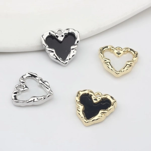 Set of four heart pendants in gold and silver finish with enamel and cutout details