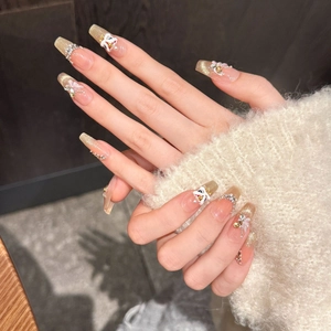 Handmade lion dance press-on nails with 3D white flowers and golden cat eye gradient