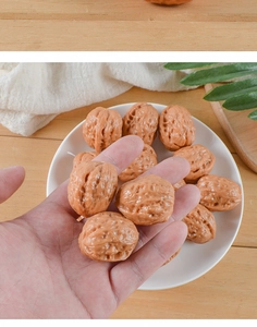 Macro shot of realistic PVC walnut models in a ceramic tray showing detailed wood texture