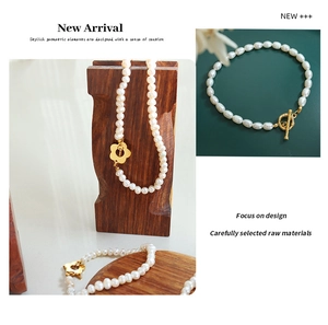 Close-up of baroque freshwater pearl necklace with gold flower OT clasp detail