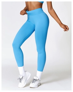Detail of high-waist yoga leggings in bright blue showing the wide tummy control waistband