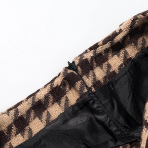 Macro detail of houndstooth wool fabric and high-quality zipper with black satin lining