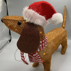 Detail of light up dachshund dog with red Christmas hat and LED glowing sequins