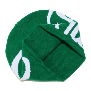 Detail view of the green ribbed knit texture and white jacquard lettering on the beanie