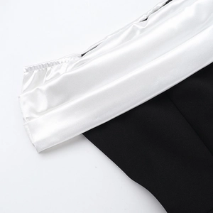 Detail shot of the black and white contrast fabric with smooth satin texture on the dress