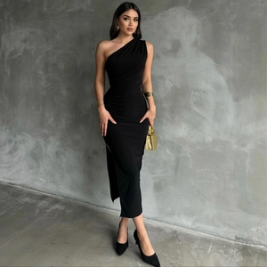 Detail of high-slit hem and side rushing on a sleek black one-shoulder slim-fit maxi dress