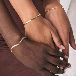 Elegant gold flat snake bone chain bracelet displayed on diverse skin tones minimalist style