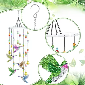 Detail of DIY diamond painting hummingbird suncatcher with colorful beads and golden bell