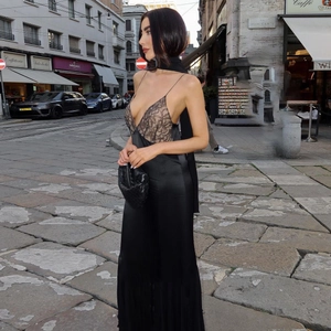 Detail of lace patchwork bodice and satin floor-length skirt on a black evening dress