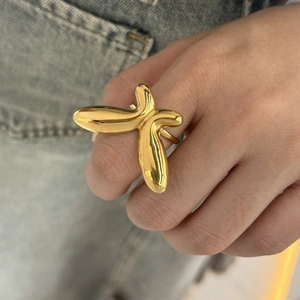 Exaggerated golden butterfly shaped ring in minimalist creative design on a hand