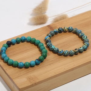 Close-up of 8mm cat eye and turquoise beaded bracelets with natural gradient textures