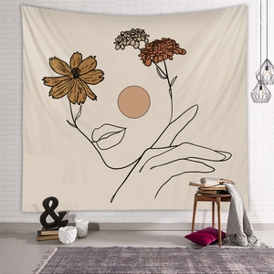 Detail of minimalist line art tapestry with floral elements on a white brick wall
