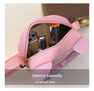 Internal capacity of pink cat-ear crossbody bag showing storage for phone and lipstick