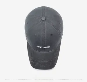 Detail view of charcoal gray baseball cap with white COYENRAT letter embroidery