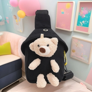 Cute kids black canvas chest bag with 3D plush bear decoration in a cozy indoor setting