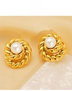 Detailed macro view of 18K gold-plated titanium steel twist earrings with white pearls