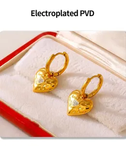 Macro shot of 18k gold plated hammered heart earrings with inlaid white crystals