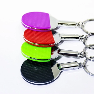 Set of four mini table tennis paddle keychains in purple, red, green, and black