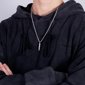 Men's silver bullet pendant necklace with twist rope chain on a model in black hoodie