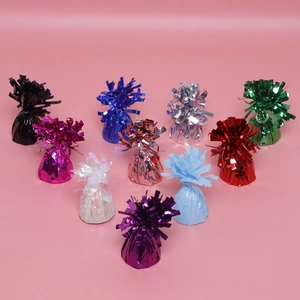 Close-up of colorful laser foil balloon weights with fringe tassels for party decor