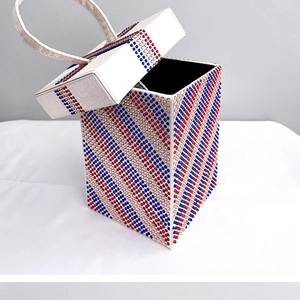 Detailed view of rhinestone evening clutch featuring red white and blue striped pattern