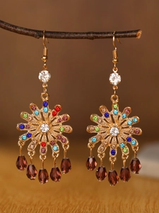 Macro shot of bohemian alloy earrings with multicolored rhinestones and water-drop pendants
