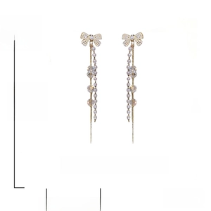 Detail of long tassel earrings with dimensions 12cm by 2cm and silver needles