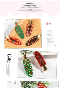 Close-up of glittery Merry Christmas hair clips with festive snowflake patterns