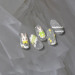 Detail of 3D embossed nail stickers featuring cute rabbits and tulip patterns