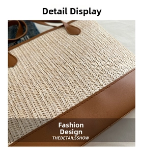 Close-up of beige woven herringbone texture with brown leather trim on a tote bag