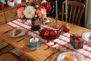 Close-up of red and white geometric cotton table runner with festive holiday decor