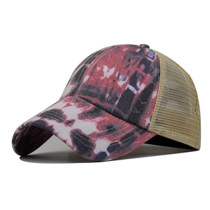 Detail view of tie-dye pattern on washed cotton visor and breathable mesh of the baseball cap