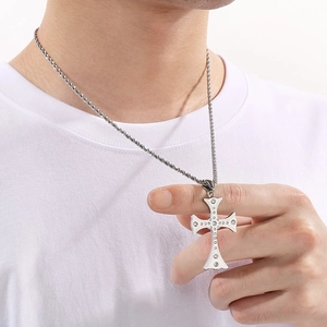 Hip hop iced out cross pendant necklace in silver stainless steel worn by a model