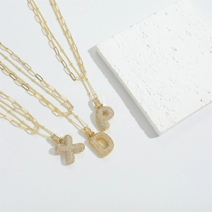 Gold layered paperclip chain necklace with zircon-studded alphabet letter pendant