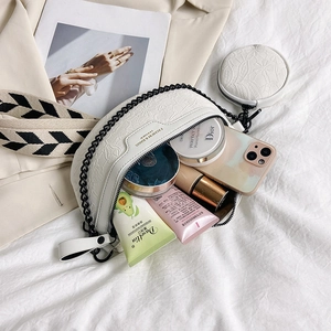 White half-moon crossbody bag with floral texture, dual straps and a round coin purse