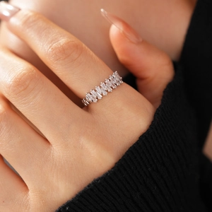 Close-up of silver ring featuring eleven baguette-cut cubic zirconia in a row
