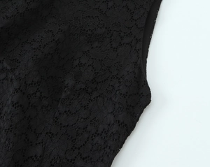 Detailed close-up showing the intricate lace patterns and fine stitching on the black sleeve