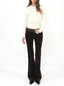 Detail of off-white wool knit top paired with dark brown corduroy flared trousers
