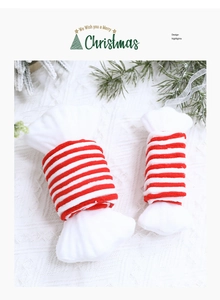 Detail of red and white striped plush candy ornaments with transparent hanging ribbons
